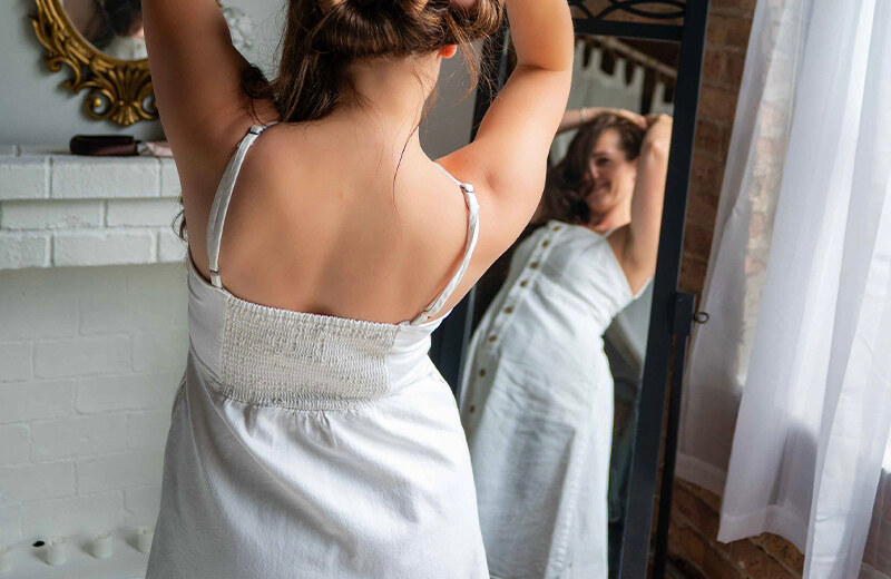 Woman getting ready in front of a mirror before a style consultation